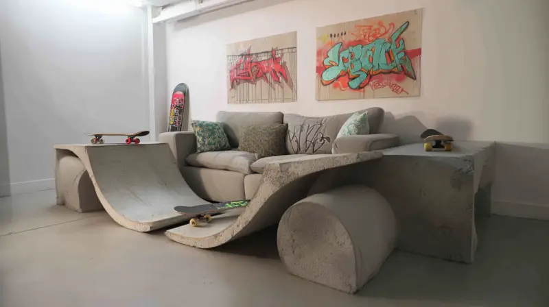 AI-generated concrete couch shaped like a skate ramp with smooth curved transitions, designed by IVA POPSURREAL and Suzan Valois